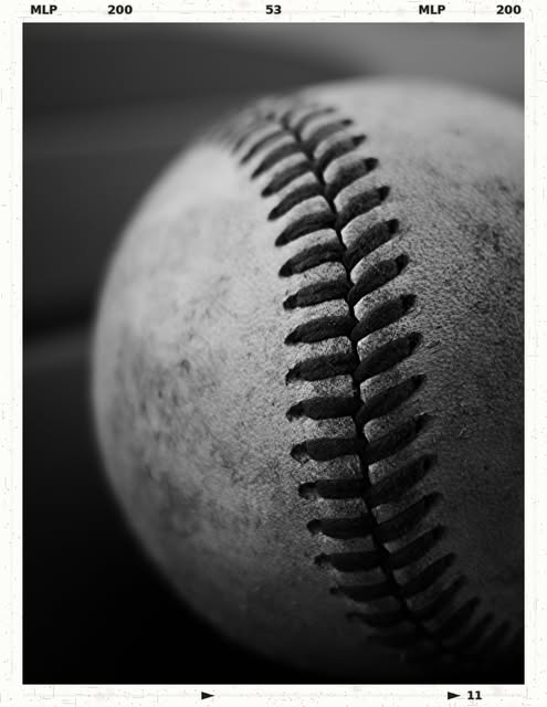 Close-up monochrome photograph of a baseball by Tony Shepherd