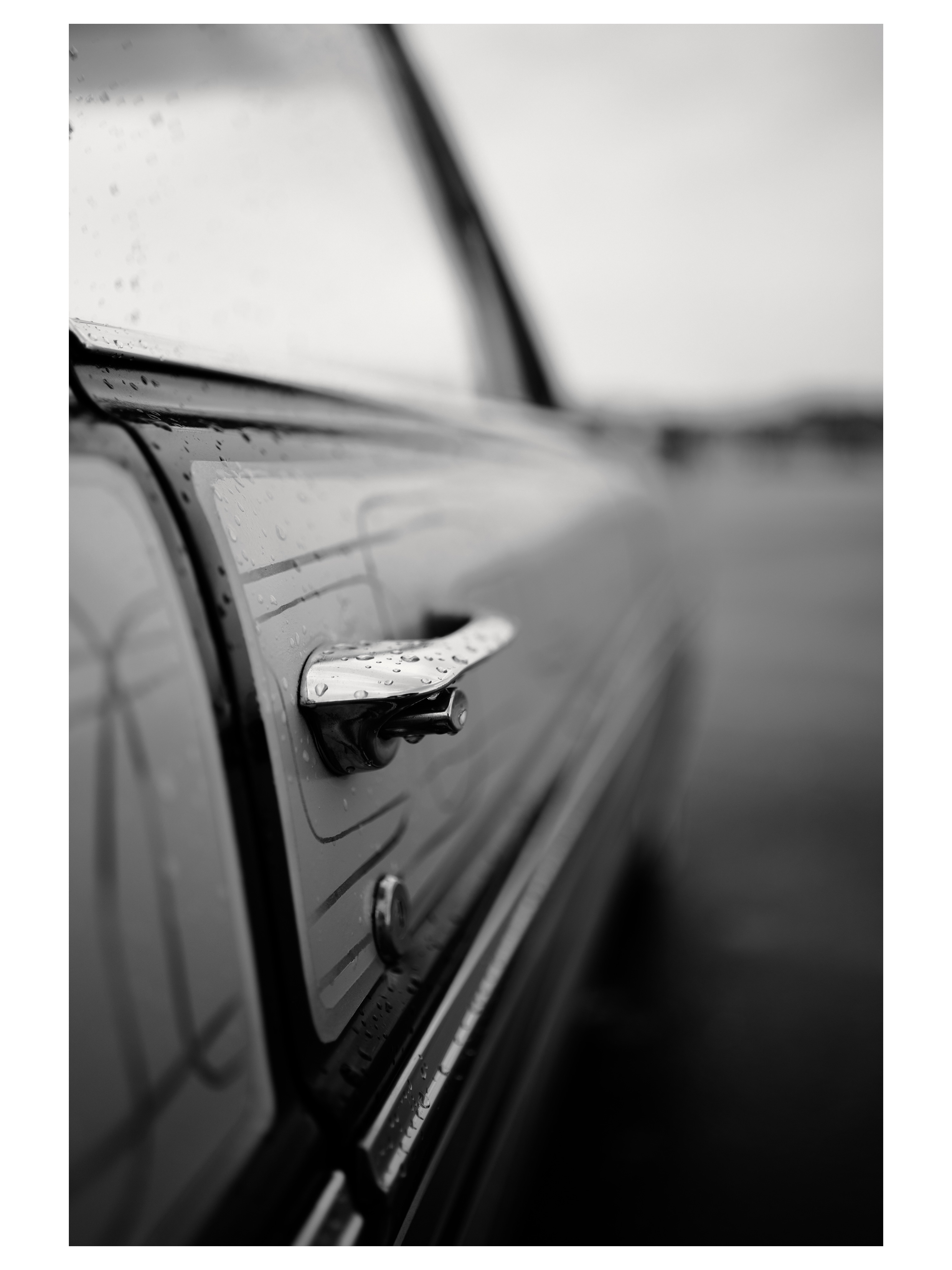 Rain-covered door detail of a classic car photographed by Tony Shepherd