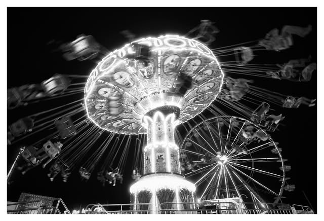 Nighttime carnival ride photographed in black and white by Tony Shepherd