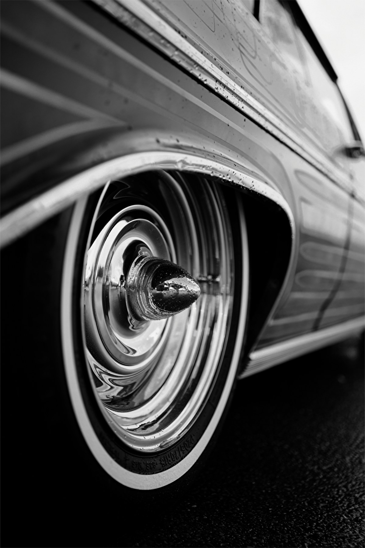 Close-up black-and-white photograph of an automobile wheel